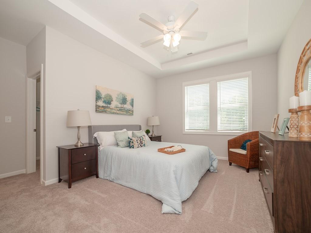 154 Rolesville Ridge Drive Rolesville, NC 27571 - Photo 6 of 9 a bedroom with a bed dresser and window