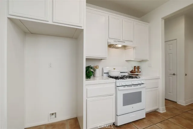 a kitchen with stainless steel appliances white cabinets and a stove