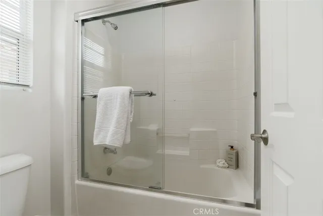 a bathroom with a glass shower door