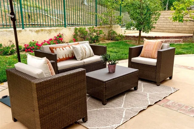 a view of a patio with couches and potted plants