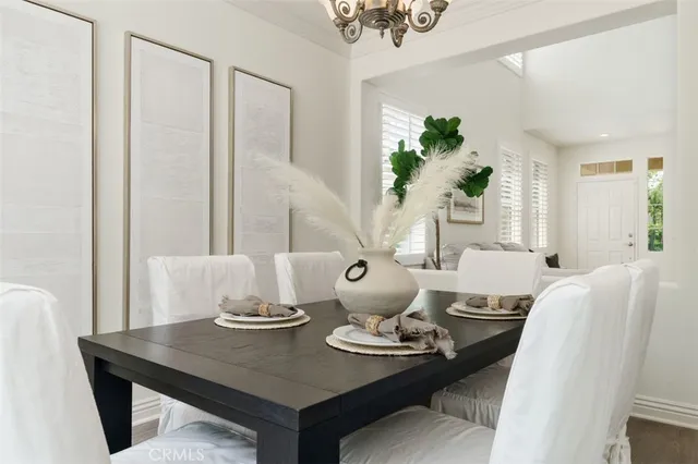 a dining room with furniture and wooden floor
