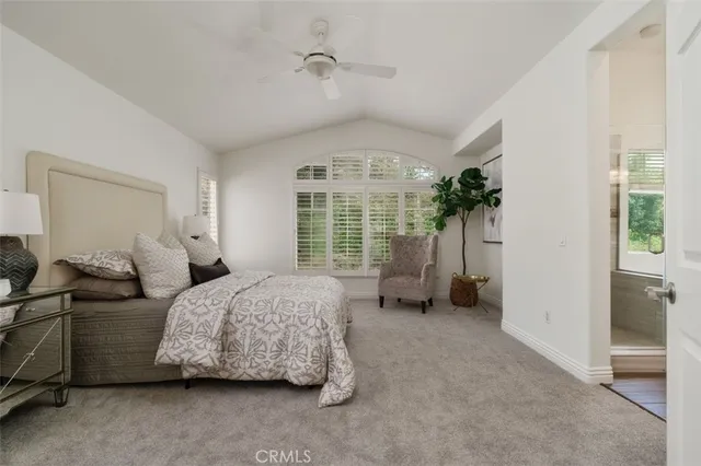 a spacious bedroom with a bed and a large window