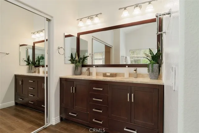 a bathroom with a double vanity sink and a mirror