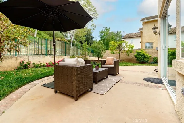 a view of a table and chairs under an umbrella