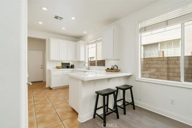 a kitchen with a sink cabinets and window