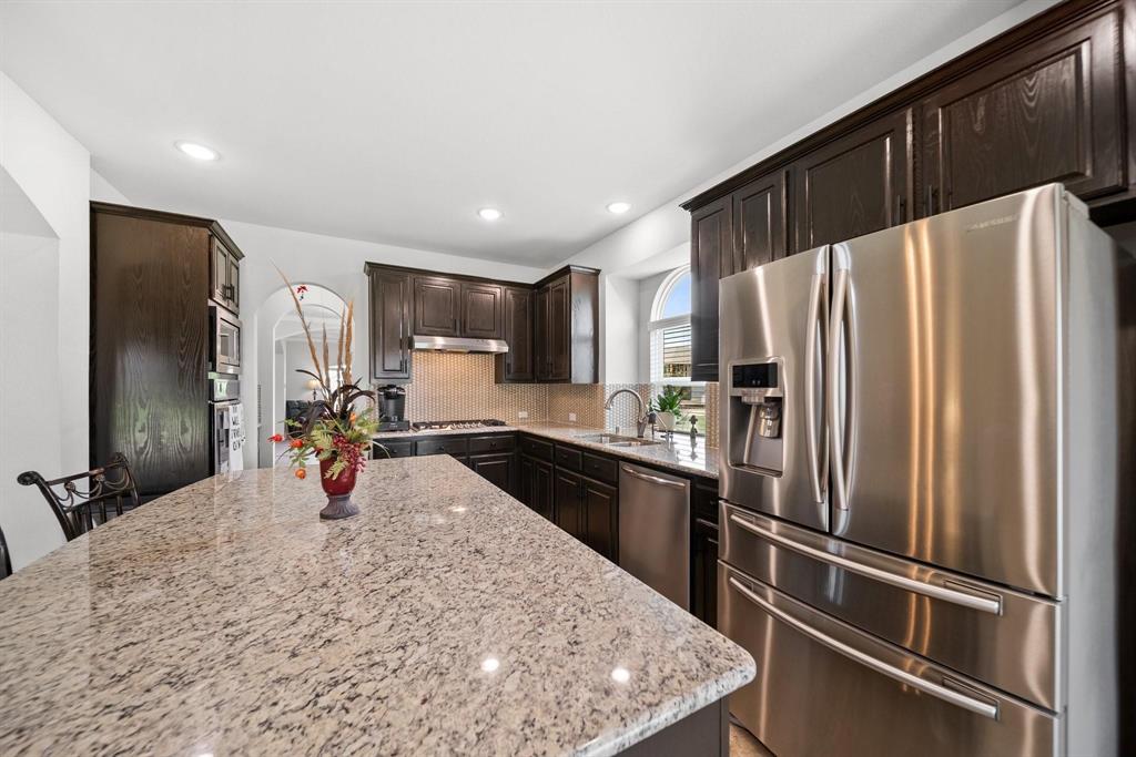 412 Bastrop Road Forney, TX 75126 - Photo 14 of 39 a kitchen with stainless steel appliances a refrigerator sink and stove