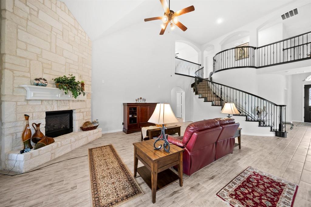 412 Bastrop Road Forney, TX 75126 - Photo 18 of 39 a living room with furniture and a fireplace