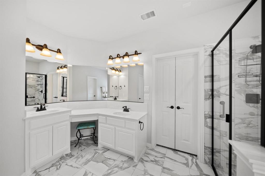 412 Bastrop Road Forney, TX 75126 - Photo 21 of 39 a spacious bathroom with a shower sink and mirror