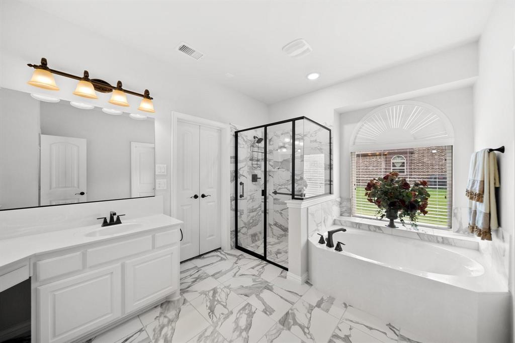 412 Bastrop Road Forney, TX 75126 - Photo 22 of 39 a spacious bathroom with a tub sink shower and mirror