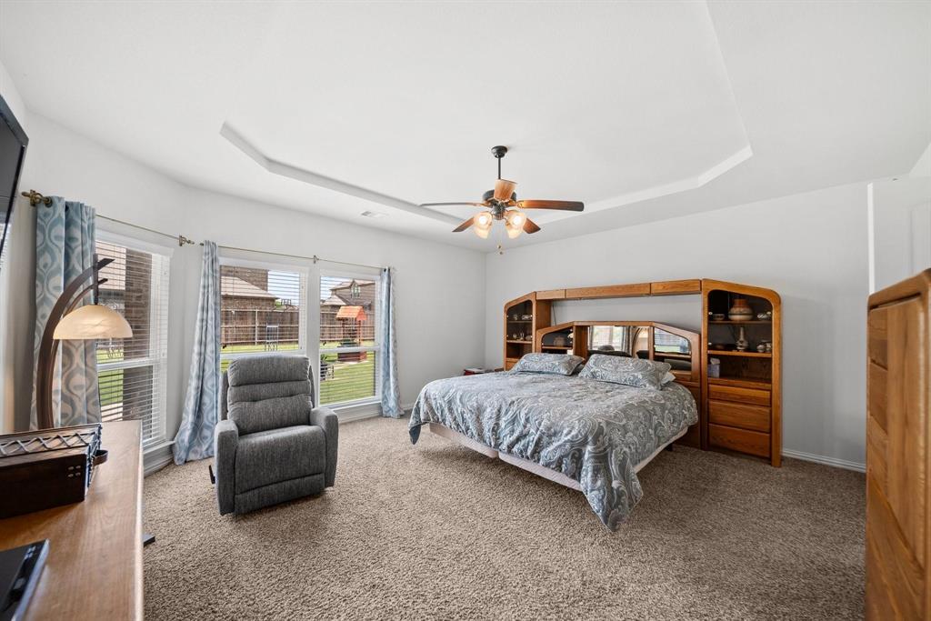412 Bastrop Road Forney, TX 75126 - Photo 23 of 39 a bedroom with a bed a couch and dresser