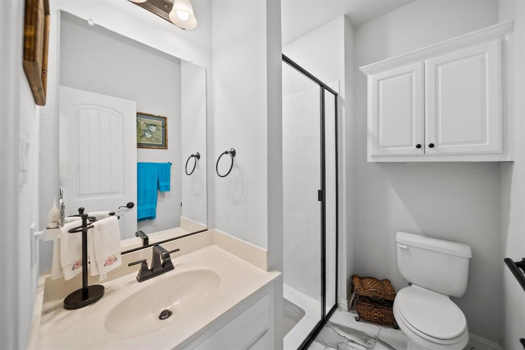 412 Bastrop Road Forney, TX 75126 - Photo 26 of 39 a bathroom with a sink a toilet and a mirror
