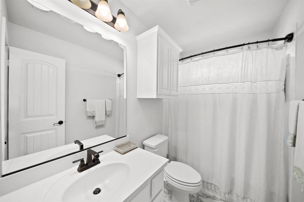 412 Bastrop Road Forney, TX 75126 - Photo 34 of 39 a bathroom with a sink a toilet and a shower