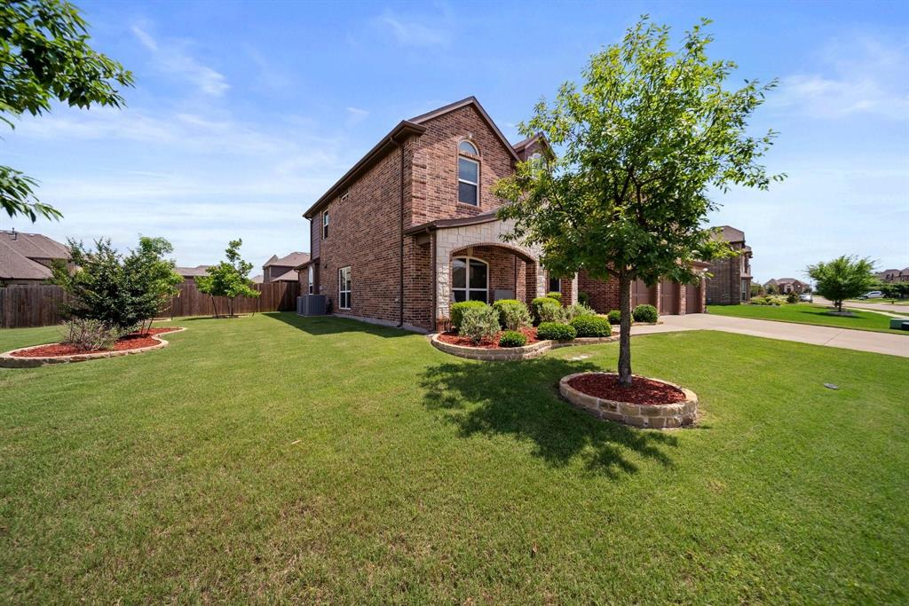 412 Bastrop Road Forney, TX 75126 - Photo 6 of 39 a front view of a house with garden and trees