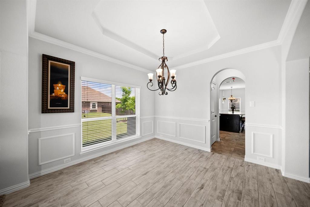 412 Bastrop Road Forney, TX 75126 - Photo 8 of 39 a view of a livingroom with wooden floor a fireplace and windows