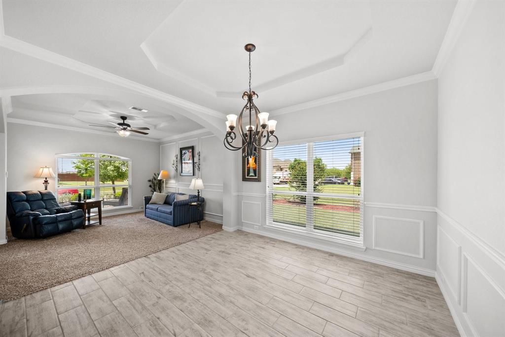 412 Bastrop Road Forney, TX 75126 - Photo 9 of 39 a living room with furniture and a chandelier
