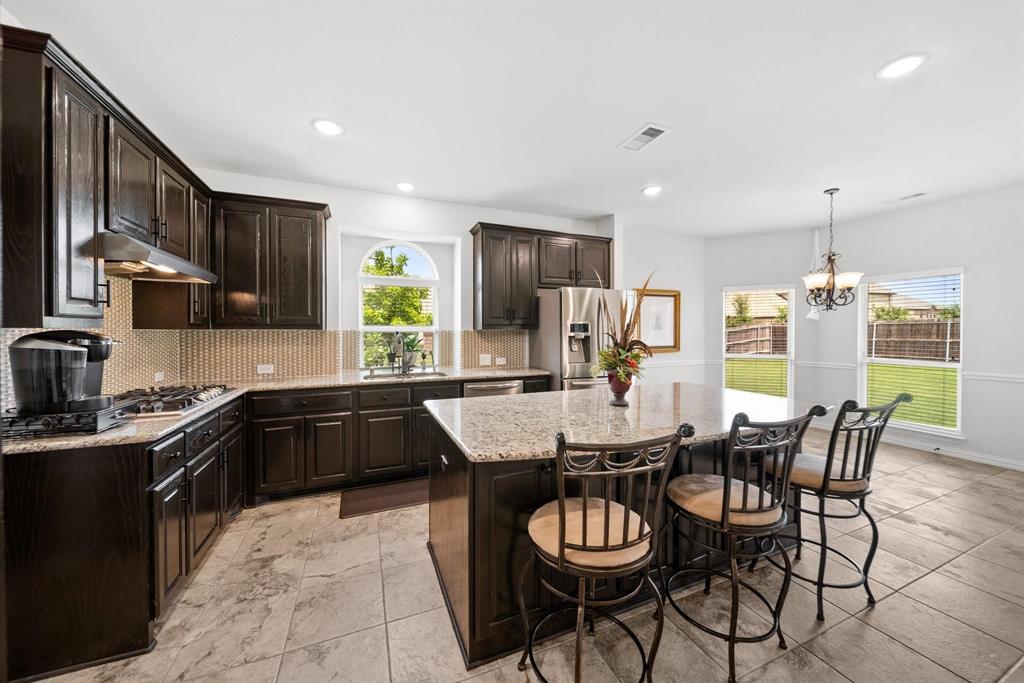 412 Bastrop Road Forney, TX 75126 - Photo 10 of 39 a kitchen with granite countertop lots of counter top space and stainless steel appliances