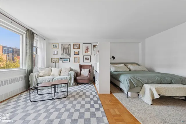 a bedroom with a bed and a couch