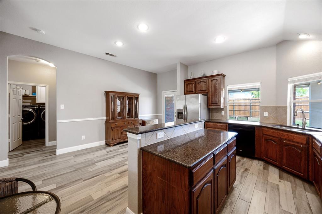 4133 Drexmore Road Fort Worth, TX 76244 - Photo 12 of 31 a kitchen with a stove a refrigerator and wooden floor