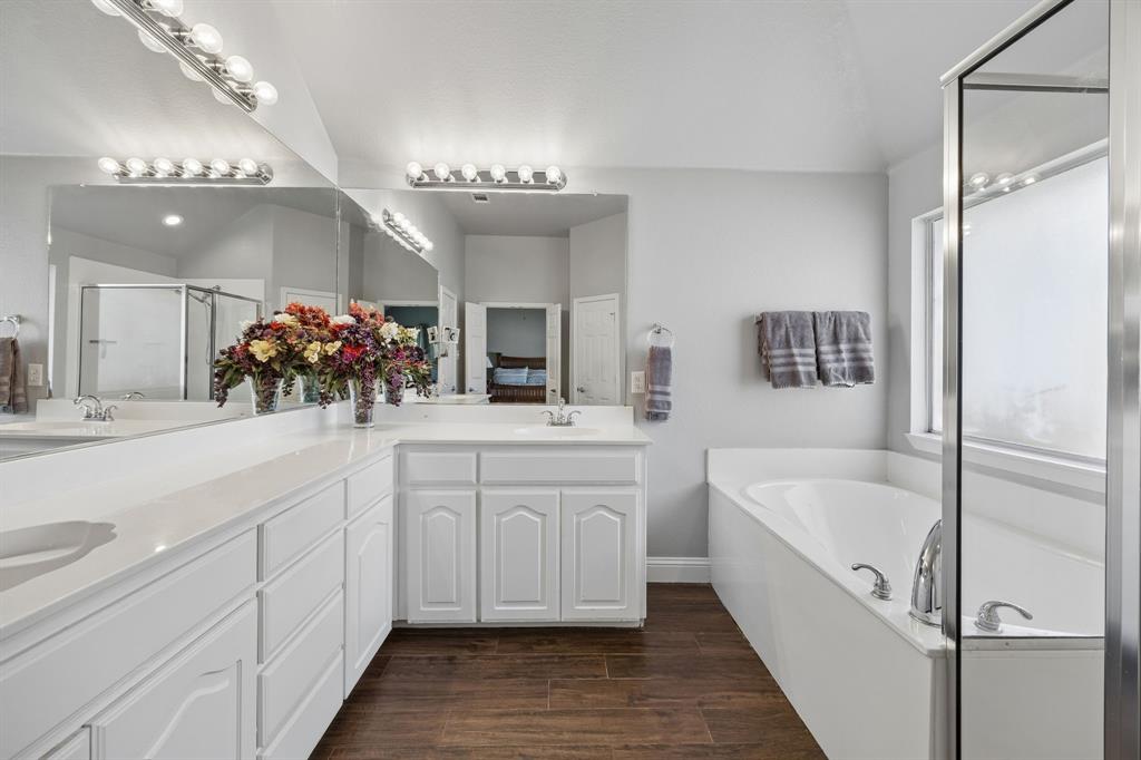 4133 Drexmore Road Fort Worth, TX 76244 - Photo 17 of 31 a bathroom with a bathtub a double vanity sink and mirror