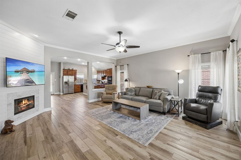 4133 Drexmore Road Fort Worth, TX 76244 - Photo 2 of 31 a living room with furniture and a fireplace