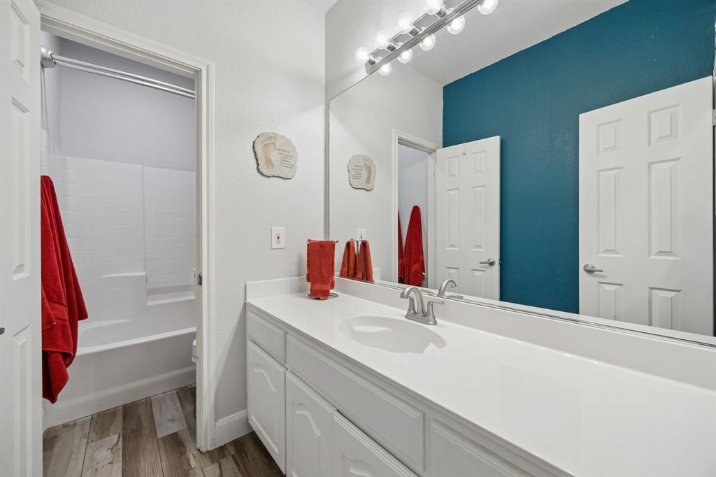 4133 Drexmore Road Fort Worth, TX 76244 - Photo 23 of 31 a bathroom with a sink vanity and a mirror