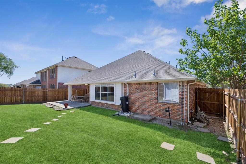 4133 Drexmore Road Fort Worth, TX 76244 - Photo 28 of 31 a backyard of a house with table and chairs