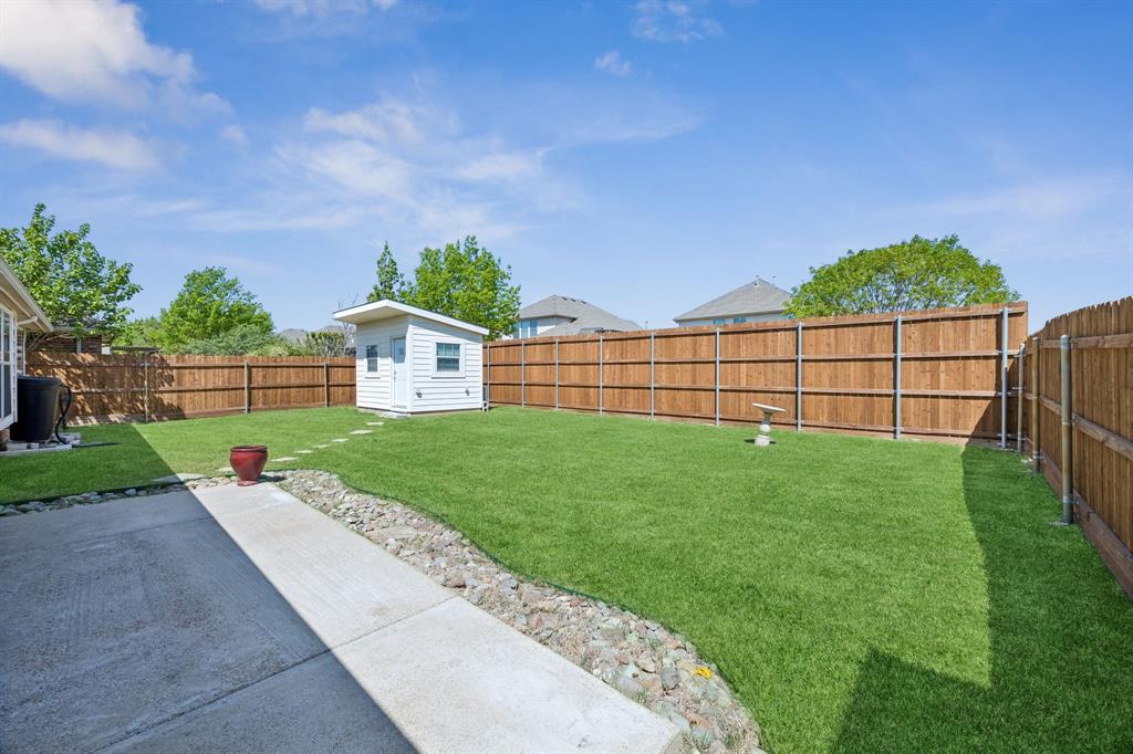4133 Drexmore Road Fort Worth, TX 76244 - Photo 29 of 31 a view of a backyard with a garden and plants