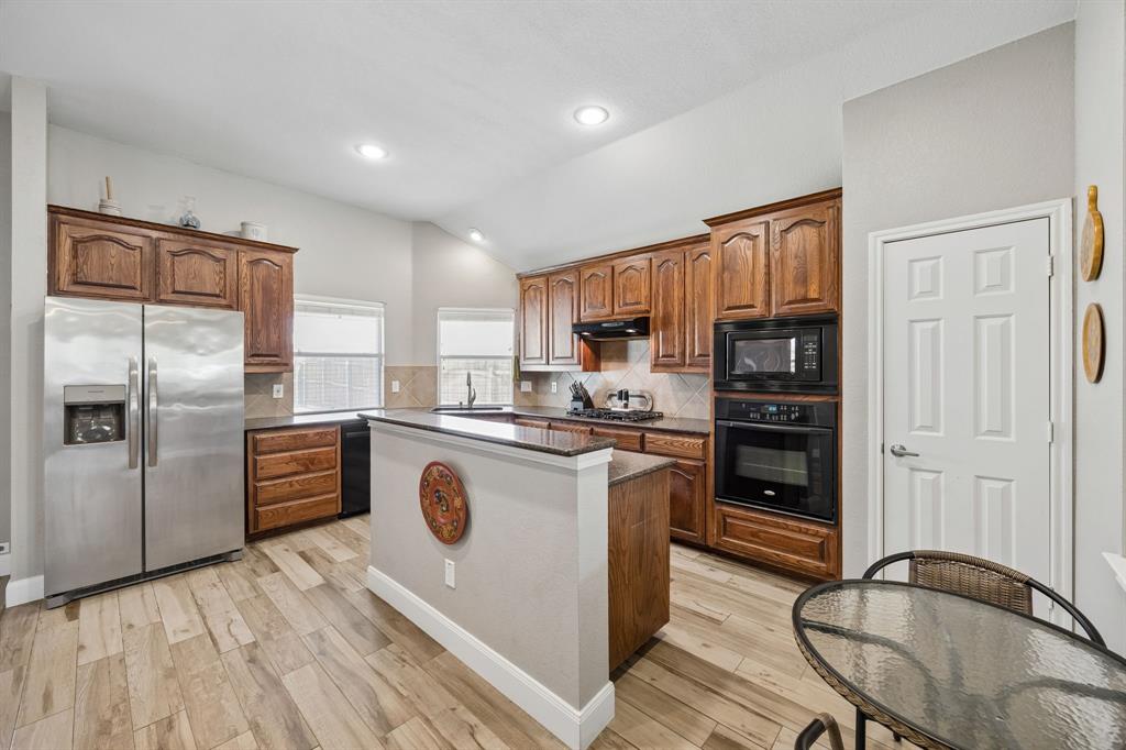 4133 Drexmore Road Fort Worth, TX 76244 - Photo 3 of 31 a kitchen with granite countertop a refrigerator stove and sink