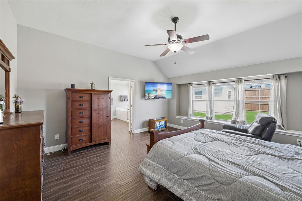 4133 Drexmore Road Fort Worth, TX 76244 - Photo 4 of 31 a bedroom with a bed and wooden floor