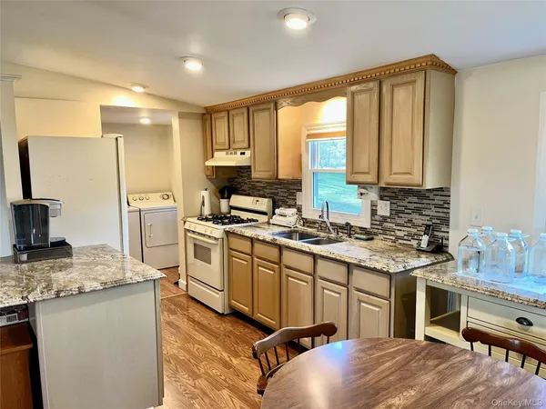 a kitchen with a stove a sink and a refrigerator