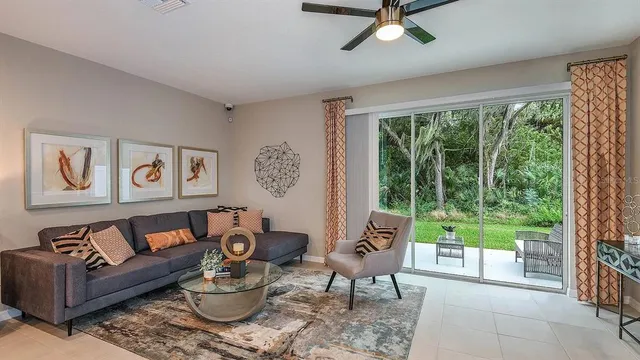 a living room with furniture and a large window