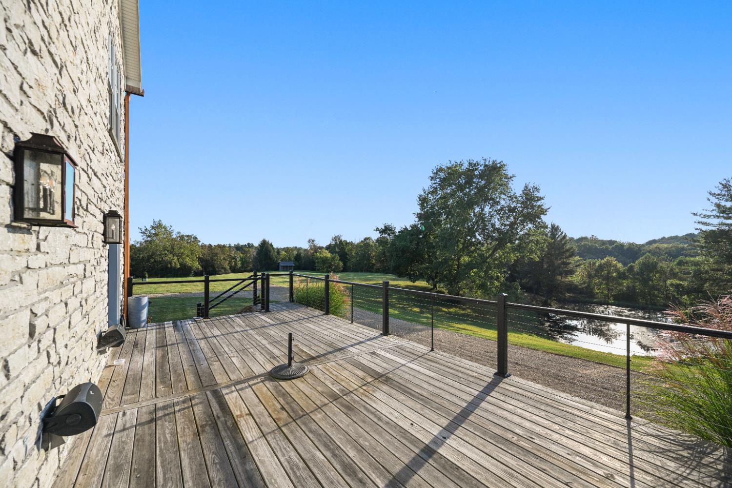 9463 Stoops Road Dillsboro, IN 47018 - Photo 14 of 99 Step out of the Great Room onto a huge side deck (14' x 29'), with views of the pond, pastures & woods beyond.