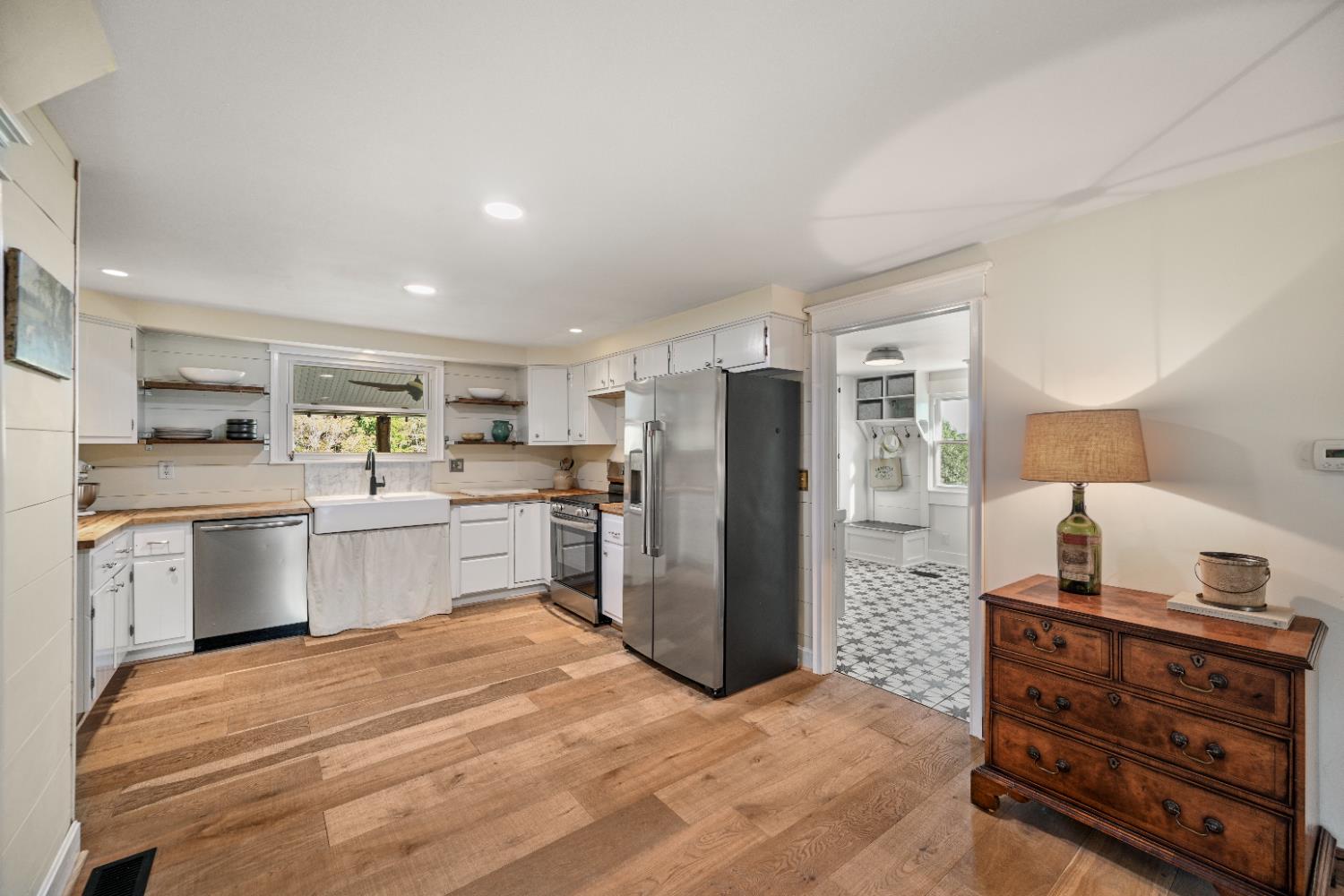 9463 Stoops Road Dillsboro, IN 47018 - Photo 20 of 99 Modern stainless appliances create a counterpoint to the oversized farm sink & butcher block countertops. Open upper shelving on opposite sides of the sink could be either old or new...
