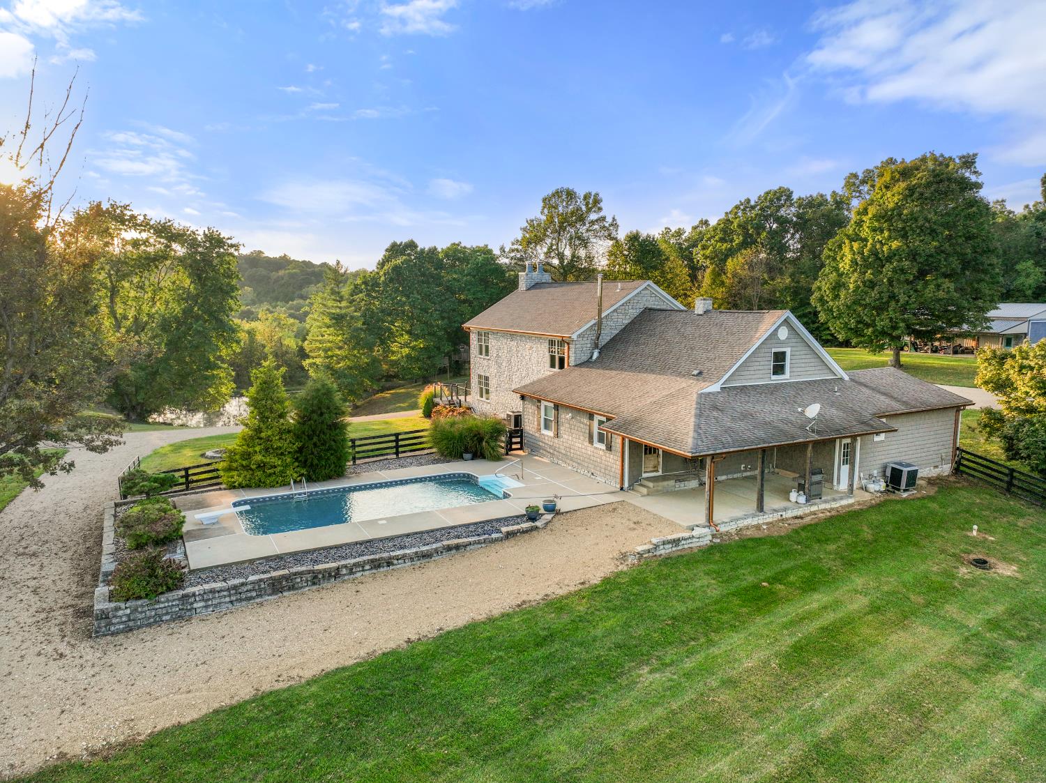 9463 Stoops Road Dillsboro, IN 47018 - Photo 3 of 99 A 16' x 32' inground pool with concrete apron and diving board is conveniently located off the rear of the house, near the covered patio.