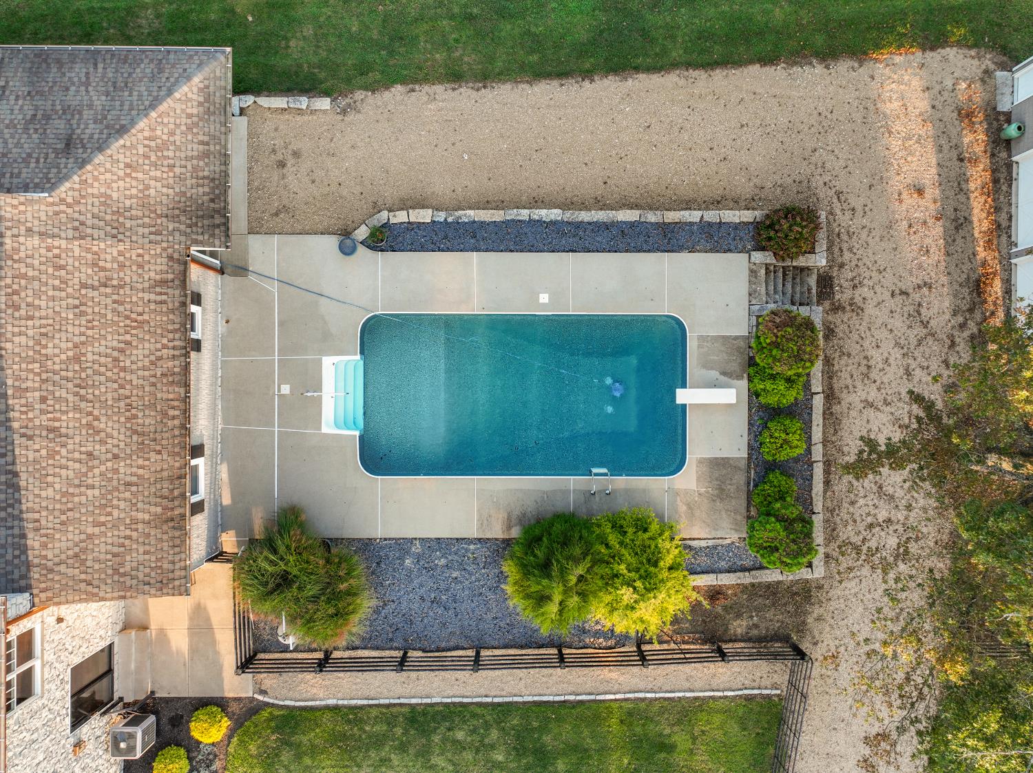 9463 Stoops Road Dillsboro, IN 47018 - Photo 32 of 99 An aerial view of the pool, showing access from the Great Room patio doors as well as the covered patio off the mudroom.