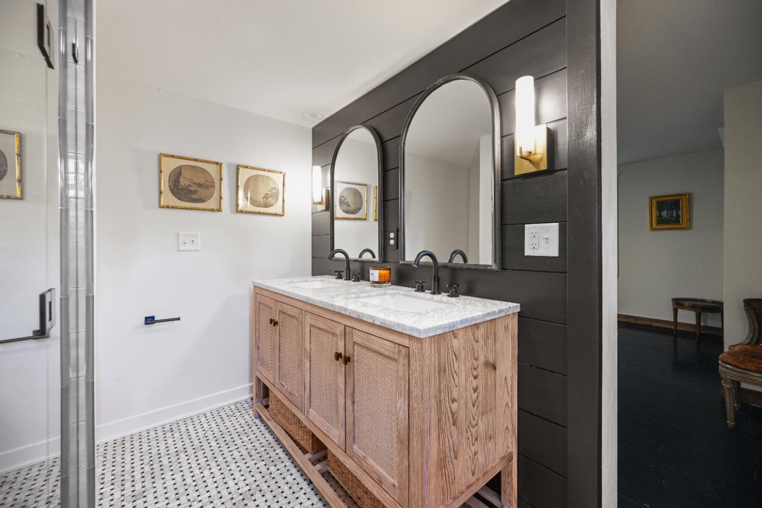 9463 Stoops Road Dillsboro, IN 47018 - Photo 35 of 99 The suite features a beautiful bathroom complete with double sink vanity, walk-in tile shower & tile floors. Dark shiplap siding installed behind the vanity provides a nice contrast to the mirrors & lighting.