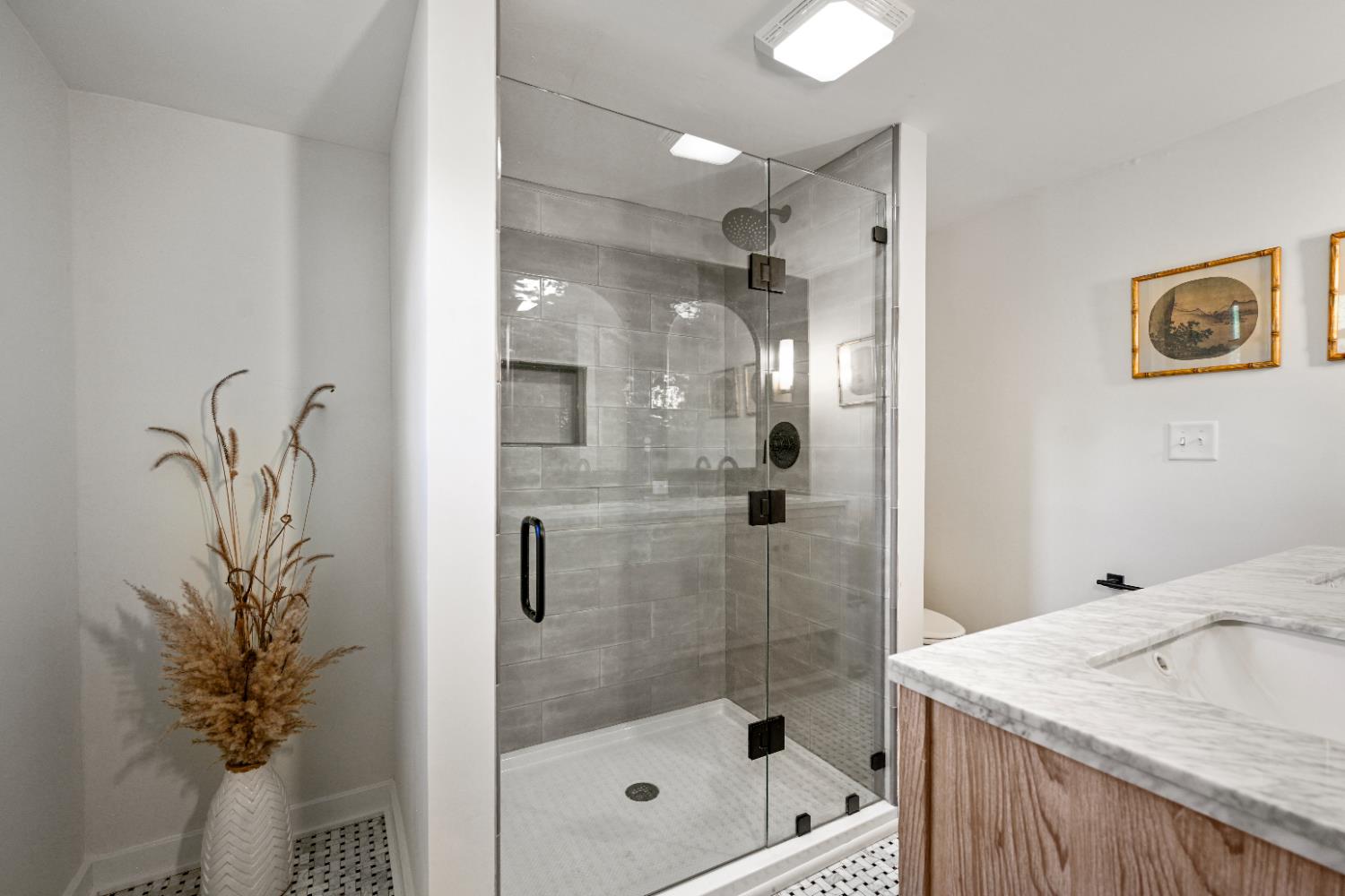 9463 Stoops Road Dillsboro, IN 47018 - Photo 36 of 99 The walk-in tile shower offers a niche for shower supplies & glass doors for easy access.