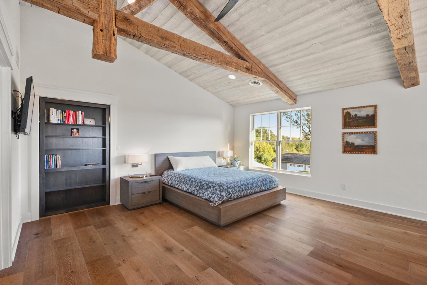9463 Stoops Road Dillsboro, IN 47018 - Photo 39 of 99 A double window overlooks the pool and pastures beyond... The bookcase is actually a functional door.