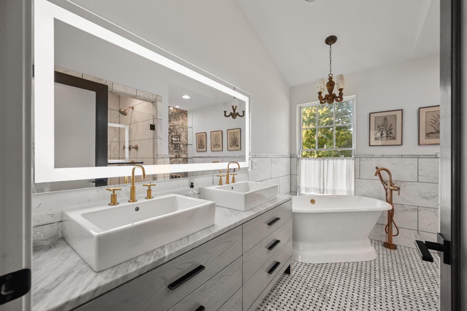 9463 Stoops Road Dillsboro, IN 47018 - Photo 41 of 99 This old-style "pamper me" bath blends old & new, and includes all the luxury features you'd expect in a high end home. Start with tile flooring, a double vanity with sinks set on top, lighted hotel mirror, marble tile wall treatments & even a chandelier over the modernized version of a clawfoot soaking tub!