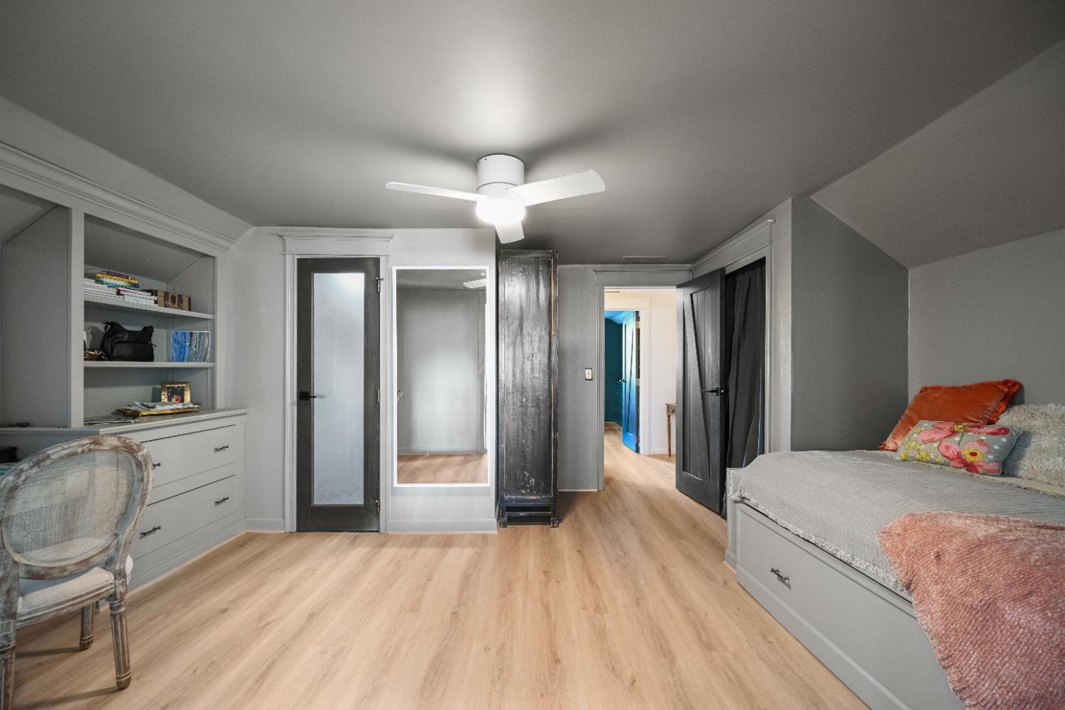 9463 Stoops Road Dillsboro, IN 47018 - Photo 48 of 99 Bedroom #4 offers a built-in bed, desk & dresser with shelves. The glass door to the left opens into a Jack & Jill bath, while the door to the right provides access to the staircase connecting to the Butler's Pantry.