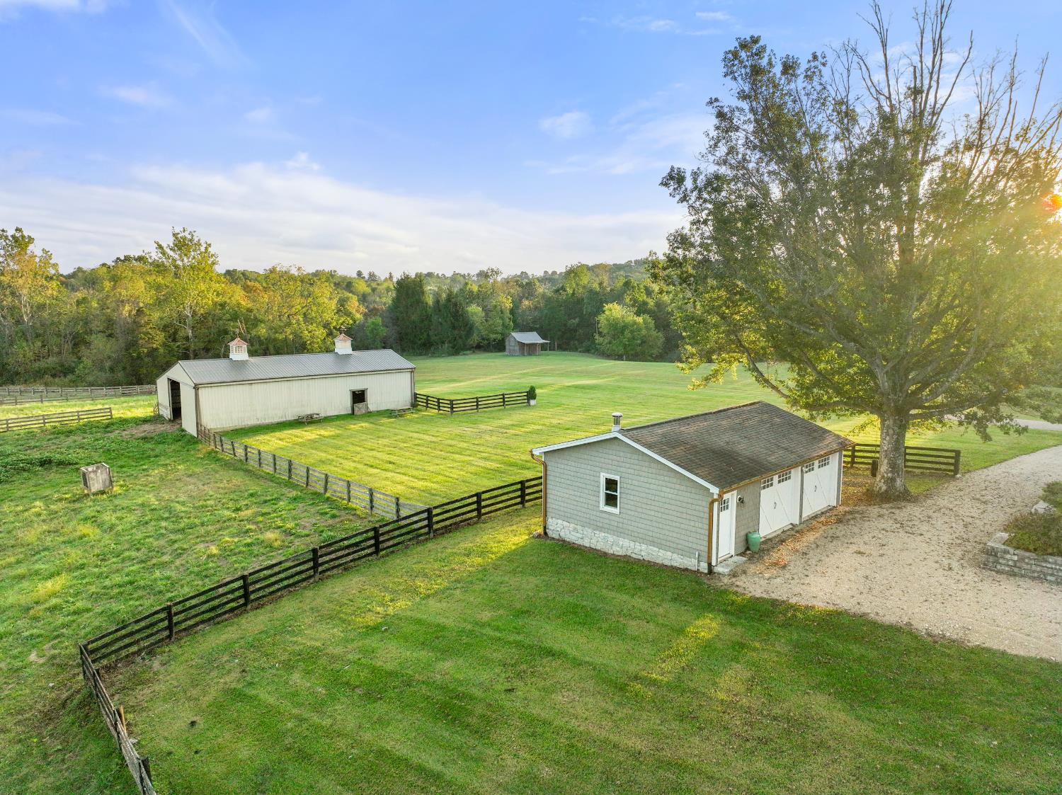 9463 Stoops Road Dillsboro, IN 47018 - Photo 52 of 99 Beyond the detached garage, a 45' x 60' horse barn features 5-6 stalls, a tack room & hay storage. Amish board fencing surrounds several pasture areas easily accessed from the barn.