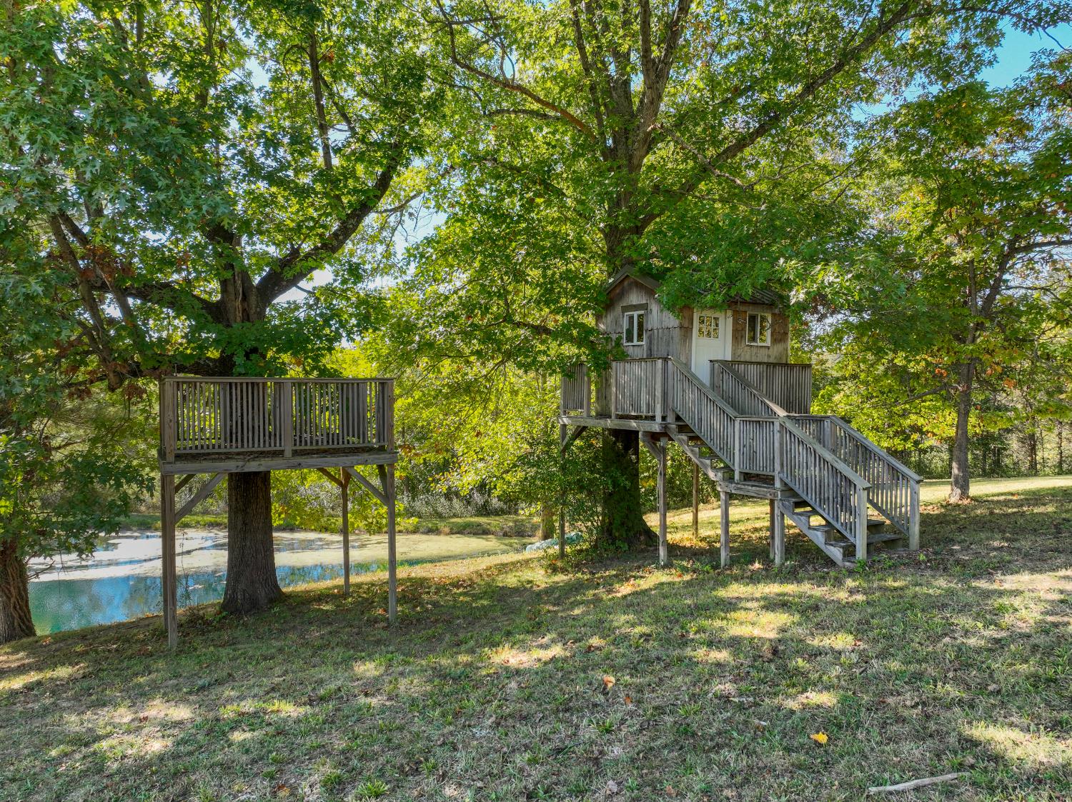 9463 Stoops Road Dillsboro, IN 47018 - Photo 68 of 99 Near the pond, an adorable tree house and adjacent deck wrapped around a nearby tree provides a great play space for the little ones!