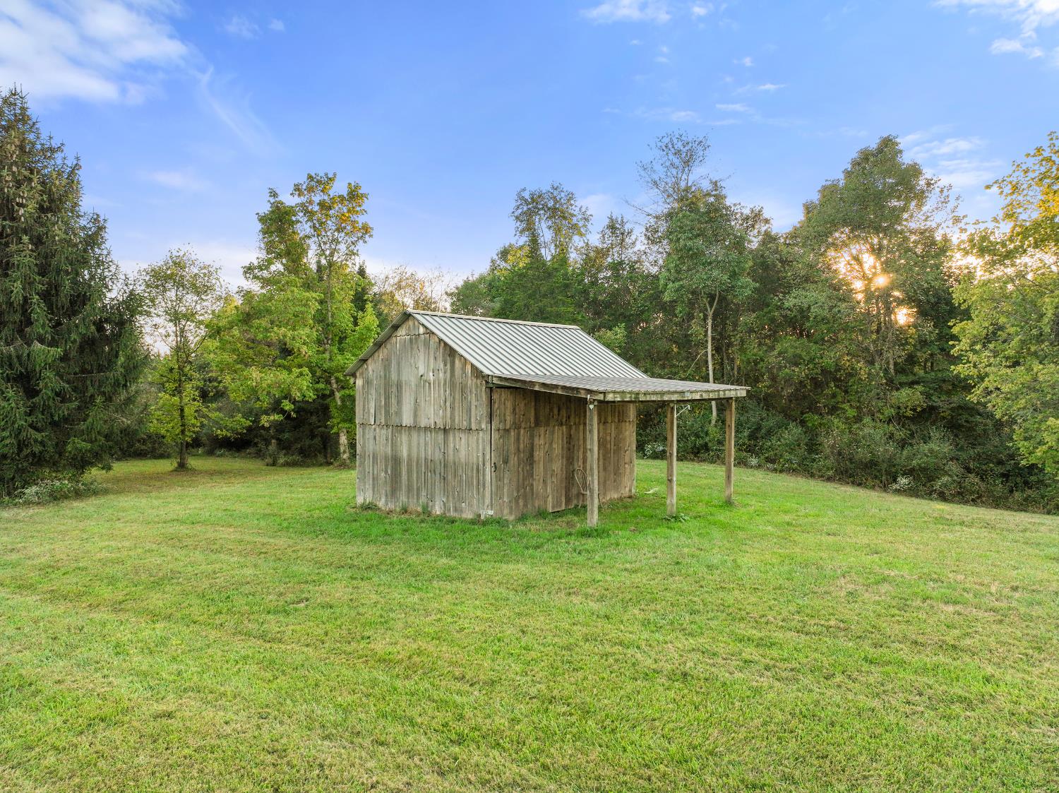 9463 Stoops Road Dillsboro, IN 47018 - Photo 71 of 99 This custom built shed, complete with double sliding doors and a covered porch area, provides storage for farm equipment, ATV's or hunting supplies.