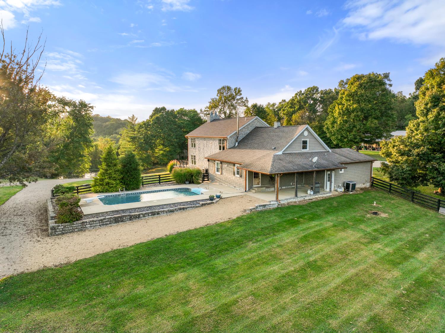 9463 Stoops Road Dillsboro, IN 47018 - Photo 79 of 99 The original part of the house, plus older additions, blend into the tranquil setting. The swimming pool is just steps from the back of the house.