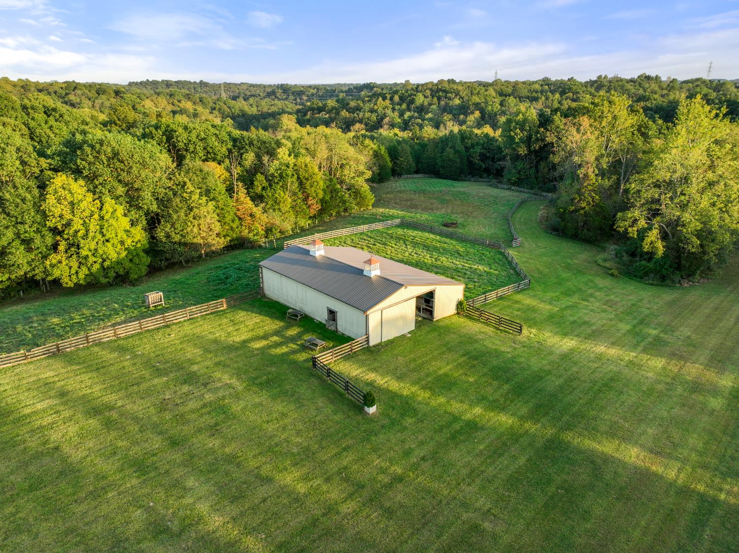 9463 Stoops Road Dillsboro, IN 47018 - Photo 81 of 99 Horse barn with pastures...a wide path to the lower pasture & creek winds down the hill to the right of the fence.