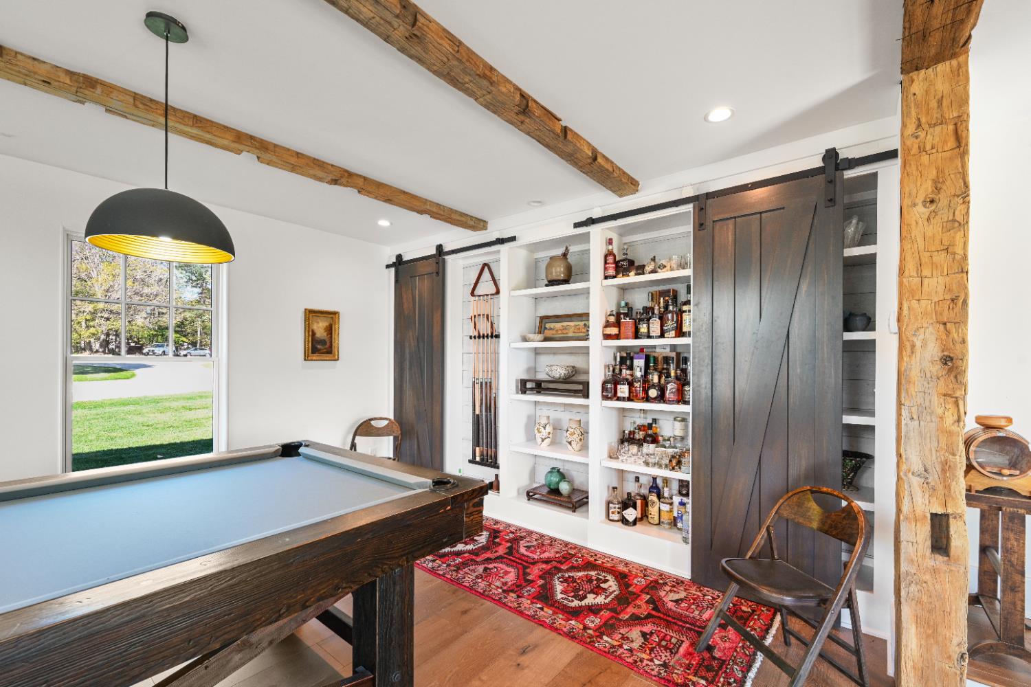 9463 Stoops Road Dillsboro, IN 47018 - Photo 10 of 99 Open the barn doors to reveal pool cue storage on the left and a convenient bar on the right!