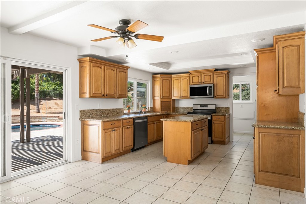 16481 Valle Vista Way Riverside, CA 92506 - Photo 14 of 73 a kitchen with granite countertop appliances cabinets and a sink