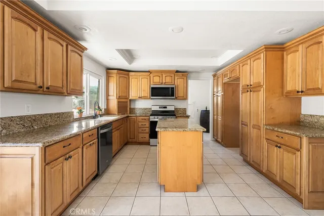 an empty room with wooden floor and natural light