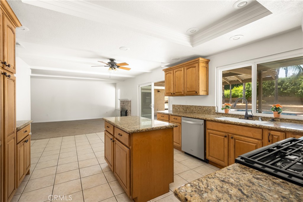16481 Valle Vista Way Riverside, CA 92506 - Photo 18 of 73 a kitchen with a sink stove and cabinets
