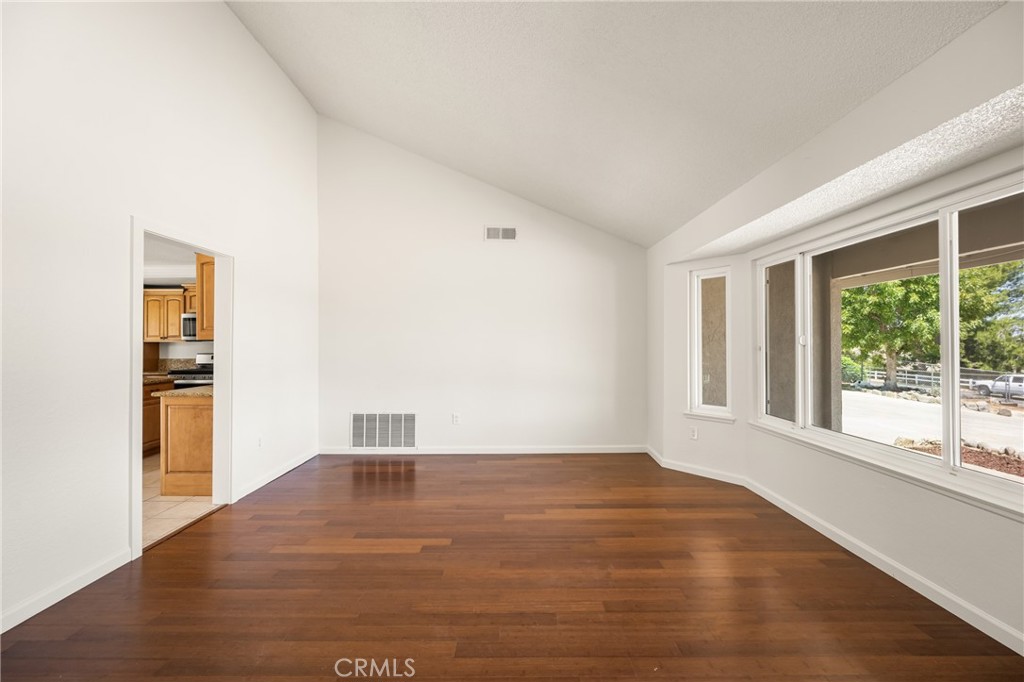 16481 Valle Vista Way Riverside, CA 92506 - Photo 20 of 73 a view of empty room with wooden floor and fan
